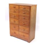 Art Deco limed oak chest of two banks of four short drawers attributed to Heals & Co, raised on
