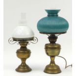 Two brass oil lamps with glass shades, one converted for electric use, the largest 53.5cm high : For