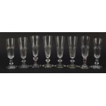 Eight 18th/19th century Champagne flutes with faceted bowls and knopped stems, the largest 17.5cm