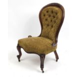 Victorian mahogany spoon back ladies chair with floral carved top rail and brown button back