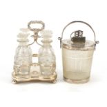 19th century silver plated and cut glass four bottle cruet and a frosted glass ice bucket in the