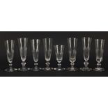 Eight 18th/19th century Champagne flutes with faceted bowls and knopped stems, the largest 17.5cm