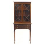 Chippendale revival Mahogany bookcase on stand, having two blind fretwork bow fronted drawers,