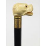 Hardwood walking stick with carved bone dog head design handle, 88cm in length : For Further