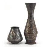 Two Indian Bidri ware vases decorated with calligraphy and foliate motifs, the largest 32cm high :