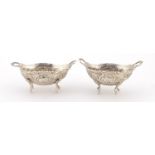 Pair of continental 80 silver salts, embossed with flowers and raised on four feet, 7cm wide, 41.