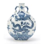 Chinese blue and white porcelain moon flask, hand painted with dragons chasing a flaming pearl above