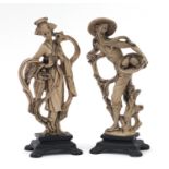 Pair of Chinese figures raised on wooden bases, the largest 33cm high : For Further Condition