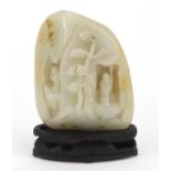 Large Chinese white and russet jade carving of figures in a mountain, raised on carved hardwood