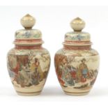 Pair of Japanese Satsuma pottery ovoid jars and covers decorated with gentlemen sitting in a