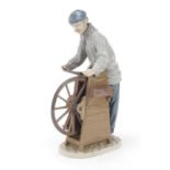 Lladro figure of a man at a grinding wheel, model 5204, 30cm high : For Further Condition Reports,
