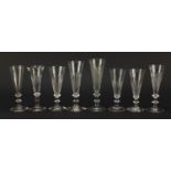 Eight 18th/19th century Champagne flutes with blade collars and knopped stems, the largest 18cm high