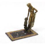 Cold painted bronze of a nude female with dog on carpet in the style of Franz Xaver Bergmann, 17cm