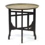Brass tray top table with folding base, 57cm high x 58cm in diameter : For Further Condition Reports