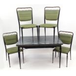 1950's green marbleised extending dining table and four painted metal chairs having green