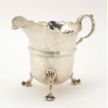 Stokes & Ireland, Edwardian silver cream jug, raised on three pad feet, Chester 1903, 8cm high,