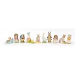 Ten Beswick Beatrix Potter figures, some with gold back stamps including Hunca Munca sweeping, The
