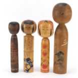 Four Japanese Kokeshi dolls with painted decoration, the largest 39cm high : For Further Condition