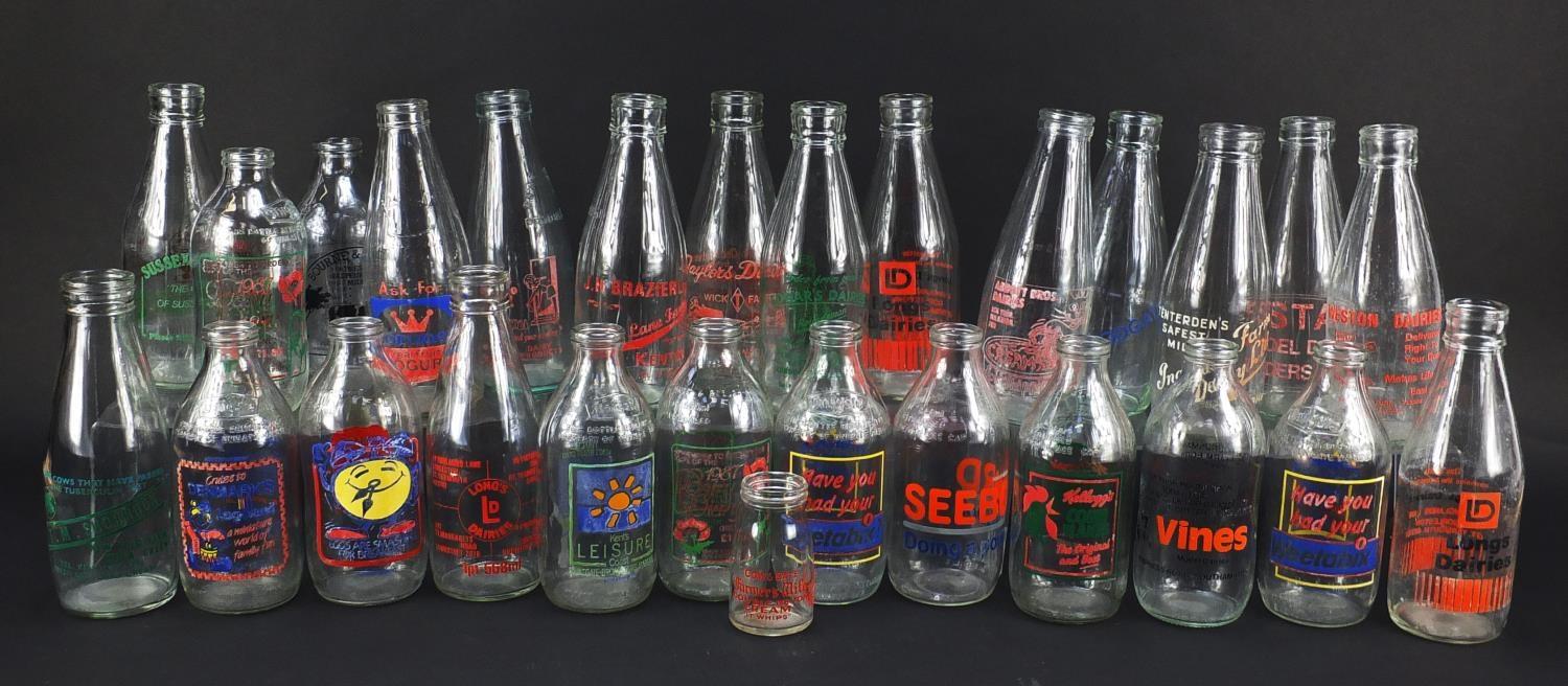 Collection of advertising milk bottles, each 18cm high : For Further Condition Reports Please