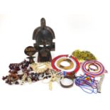 African tribal interest items including a carved wood face mask, beadwork necklaces and a carved