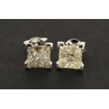 Pair of 18ct white gold princess cut diamond stud earrings, approximately 3 carats in total, 2.