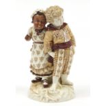 Continental porcelain figure group of two children hand painted with flowers, factory marks PF to