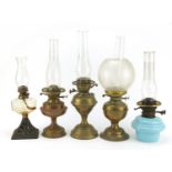 Five brass and glass oil lamps, the largest 51cm high : For Further Condition Reports Please Visit