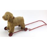 Vintage golden straw filled push along dog, 45cm in length : For Further Condition Reports Please