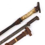 African cane with carved bone figural handle and a steel bladed sword with leather sheaf, the