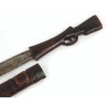 African carved wood sword in the form of a rifle with steel blade, 71cm in length : For Further