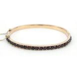 Antique gilt metal and garnet hinged bangle, 6cm x 5cm, 9.7g : For Further Condition Reports