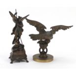 Bronzed winged figure slaying a dragon and an eagle mascot, the largest 21cm high : For Further