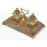 19th century copper and brass desk stand with two cut glass inkwells, the stand embossed with