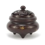 Chinese gold splashed patinated bronze tripod incense burner with pierced lid, four figure character