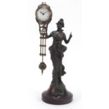 Patinated bronzed mystery clock in the form of an Art Nouveau female, 33.5cm high : For Further