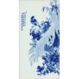 Chinese blue and white panel housed in a carved hardwood frame, hand painted with a bird on a rock