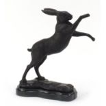 Patinated bronze boxing hare raised on a shaped black marble base, 30cm high : For Further Condition