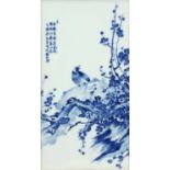 Chinese blue and white panel housed in a carved hardwood frame, hand painted with a bird on a rock