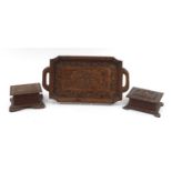 Black Forest style twin handled tray and two caskets carved with peacocks and a stag, the tray