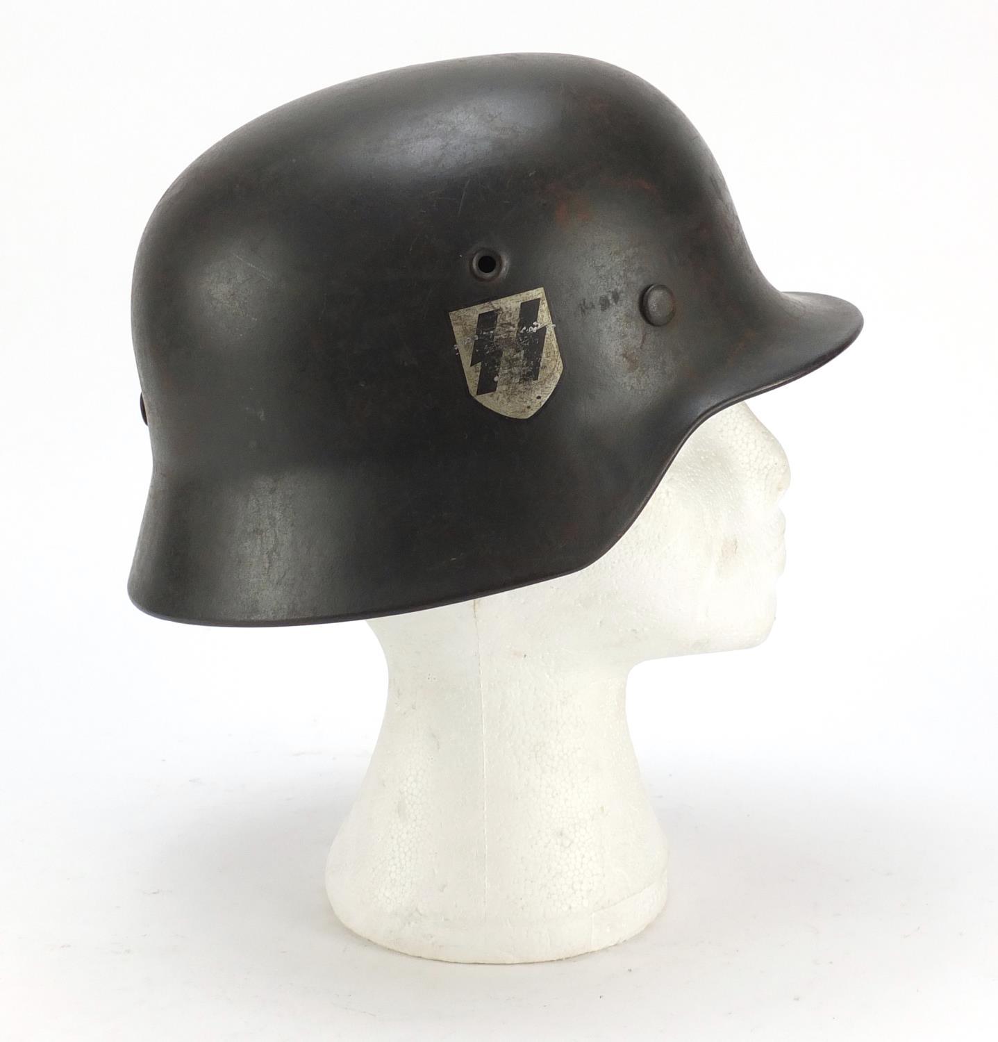 German military interest steel helmet with SS badge and leather liner, impressed 1256 and ET64 : For - Image 4 of 6