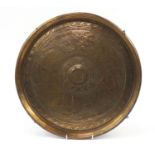 Circular brass gong engraved with dancing figures and wild animals, possibly Indian, 39cm in