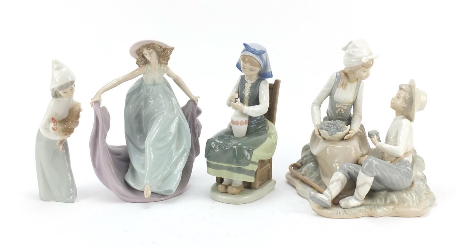 Four Lladro and Nao figure groups, the largest 23cm high : For Further Condition Reports Please