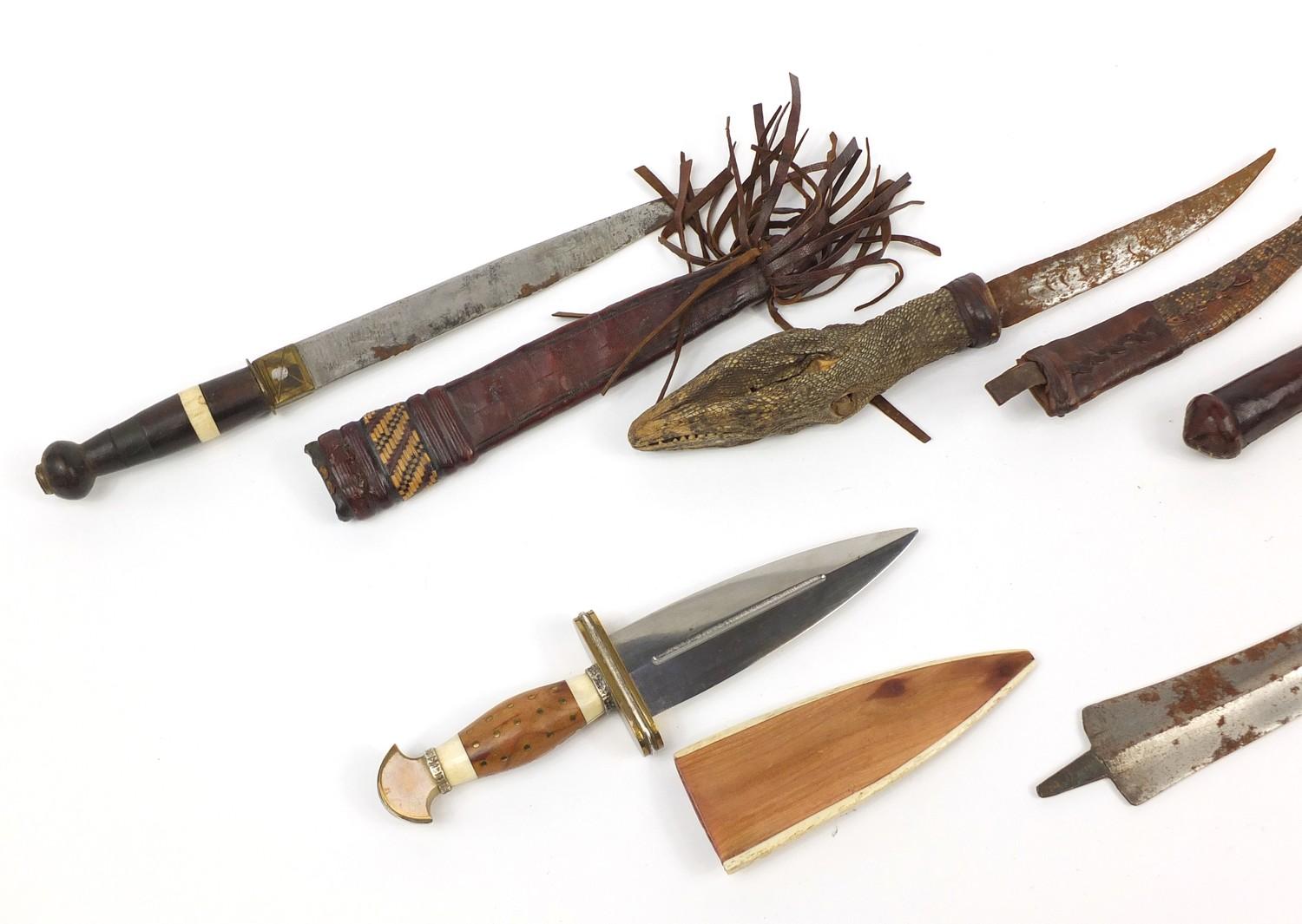 Seven daggers including a taxidermy interest example with lizard head handle, the largest 35cm in - Image 7 of 9