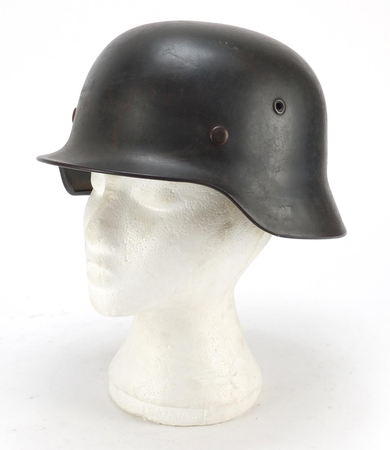 German military interest steel helmet with SS badge and leather liner, impressed 1256 and ET64 : For