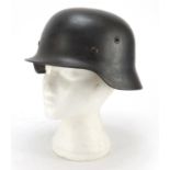 German military interest steel helmet with SS badge and leather liner, impressed 1256 and ET64 : For