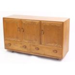 Ercol Windsor elm sideboard with three cupboard doors above two drawers, 76cm H x 130cm W x 43cm D :