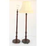Pair of carved mahogany standard lamps, one with shade, each 130cm high excluding the fitting :