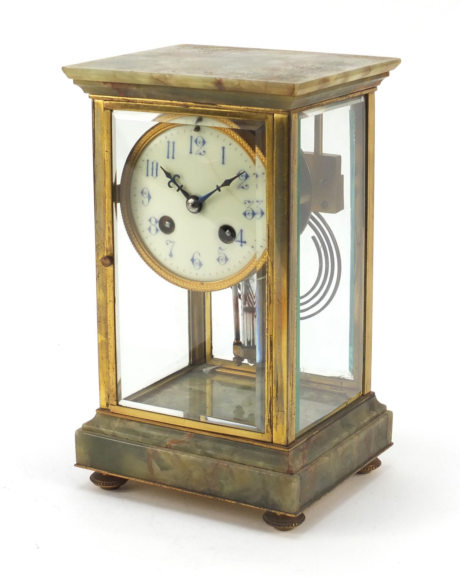 19th century French onyx and brass four glass mantle clock striking on a gong, the enamelled dial