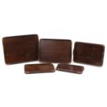Graduated set of five oak trays with copper mounts, the largest 62cm x 44cm : For Further