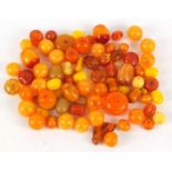 Loose amber coloured beads, the largest 3cm in length, 280.0g : For Further Condition Reports Please